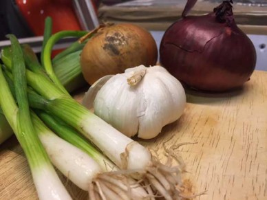 Premium Photo  A sack of garlics shallots and onions